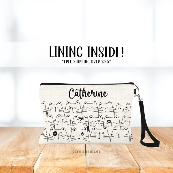 This linen zipper pouch with strap shows a stack of cats in a line art design. And is personalized with your name at the top.