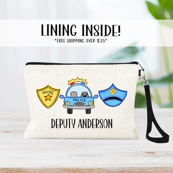 This linen wristlet features a cute police officer design with a badge, car, and hat. Perfect personalized gift for your schools resource officer.