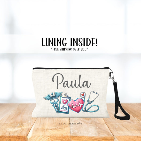 Linen wristlet bag with black strap. Personalized with medical items - symbol, clipboard that says #1 Nurse, Heart and stethoscope. The top says your name.