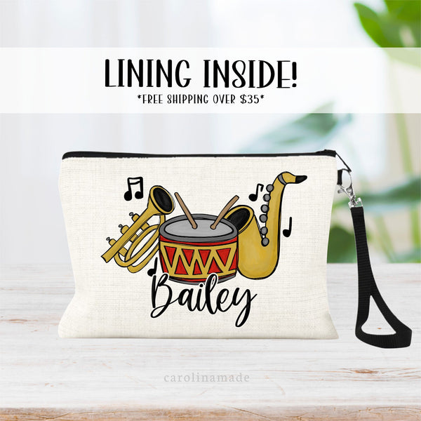 This linen zipper pouch features music notes, a trumpet, saxophone and drums. It is personalized with band members name at the bottom.