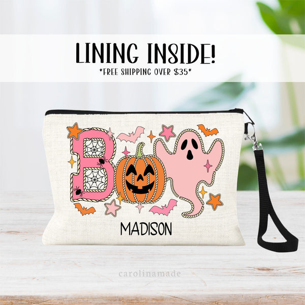 This linen zipper pouch features the word BOO in fun design with spiders, bats, pumpkins and ghosts. It is personalized at the bottom with your name.