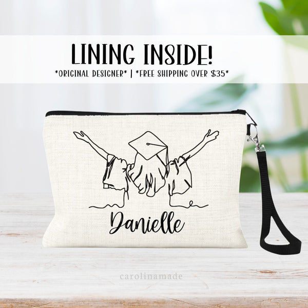 Linen zipper pouch featuring graduation line art design with girl in a graduation gown and cap. It is personalized with your name at the bottom.