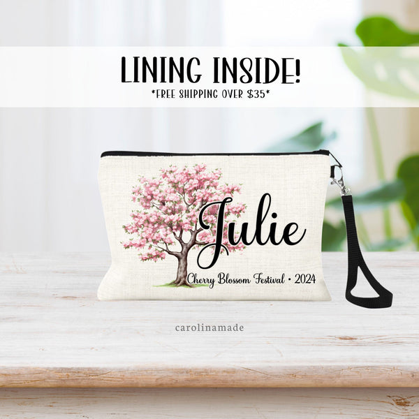 Linen wristlet with a cherry blossom tree. Personalized with name. and at the bottom the text says Cherry Blossom Festival 2024. Perfect accessory for your Cherry Blossom festival trip