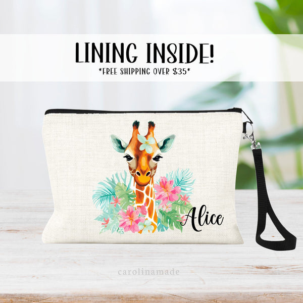 This linen zipper pouch features a large giraffe next & head. With pink flowers, greenery and palm leaves. It is personalized in the corner with your name.
