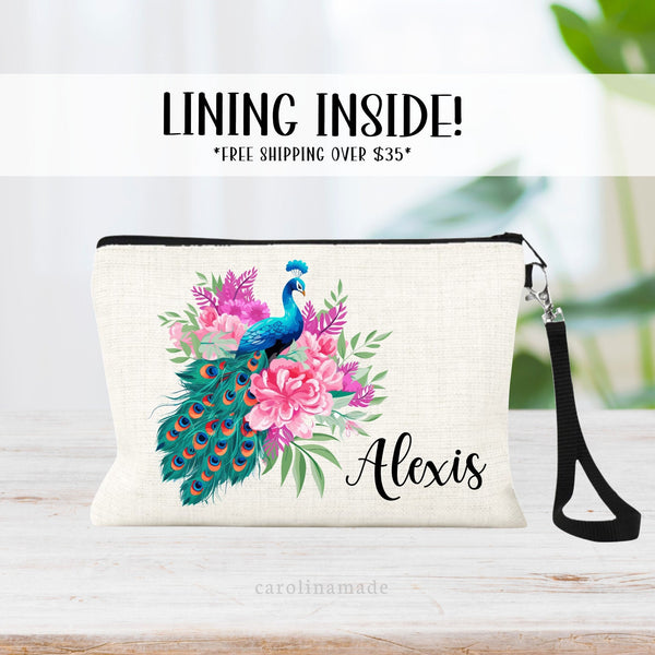 This linen zipper pouch features a pretty pink floral and greenery design with a peacock in the center. It is personalized in the corner with your name.
