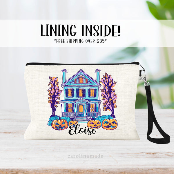 This linen wristlet features a fun colorful spooky halloween house with cut out pumpkins. And is personalized with your name on the bottom.