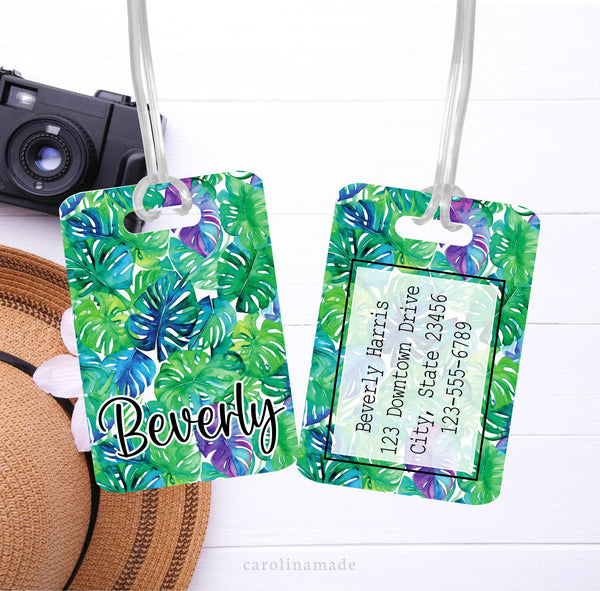 Bright green, blue and purple palm leaves luggage tag that is personalized with your name on the front and contact information on the back.