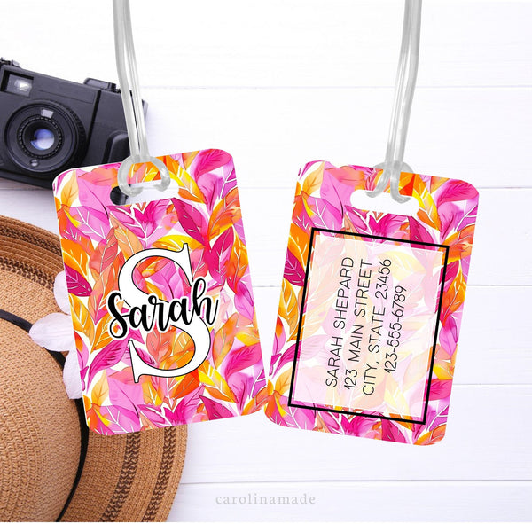 Pink and Orange fall leaves cover this luggage tag. It is personalized on the front with your initial and name. Your contact information is on the back.