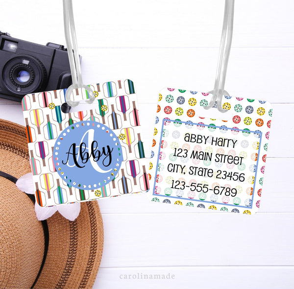 This square bag tag features a fun pickleball pattern on both sides. The front shows rows of pickleball paddles and has your name. The bag shows rows of pickleball balls and is personalized with your contact information.