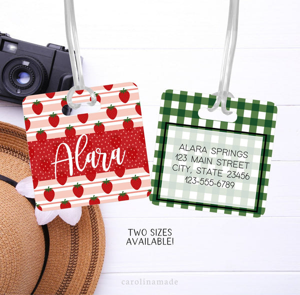 Strawberry luggage tag with name on the front and personalized contact information on the back.