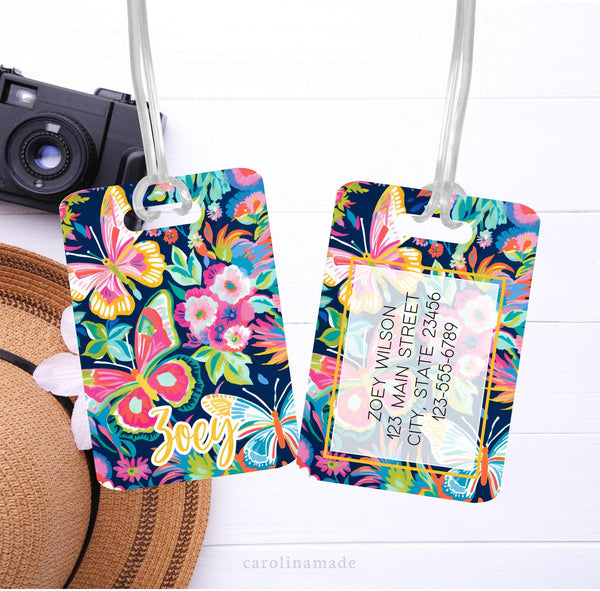 This aluminum luggage tag features a colorful preppy butterfly design on both sides. The front has a name. And the back is personalized with contact info.