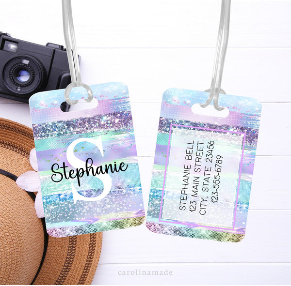 This luggage id tag features a purple glitter brush stroke design with large initial and name on the front. The back is personalized with contact information.