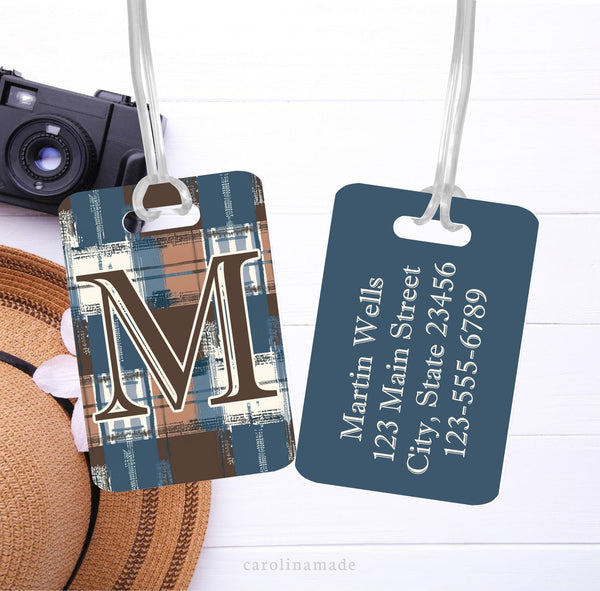 This luggage ID Tag features a blue and brown plaid design on the front with large initial. The back has matching solid blue color with his personalized contact information.