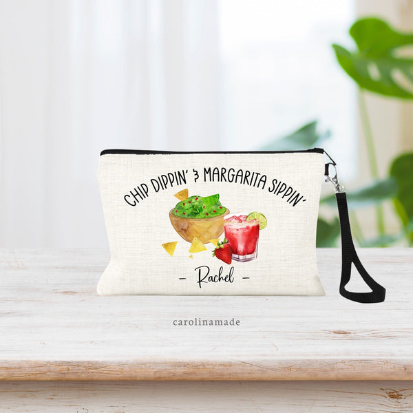 This linen wristlet is perfect for girls Margarita night! It says at the top: Chip Dippin & Margarita Sippin. The bag features guacamole dip with a strawberry margarita. The bottom is personalized with your name.