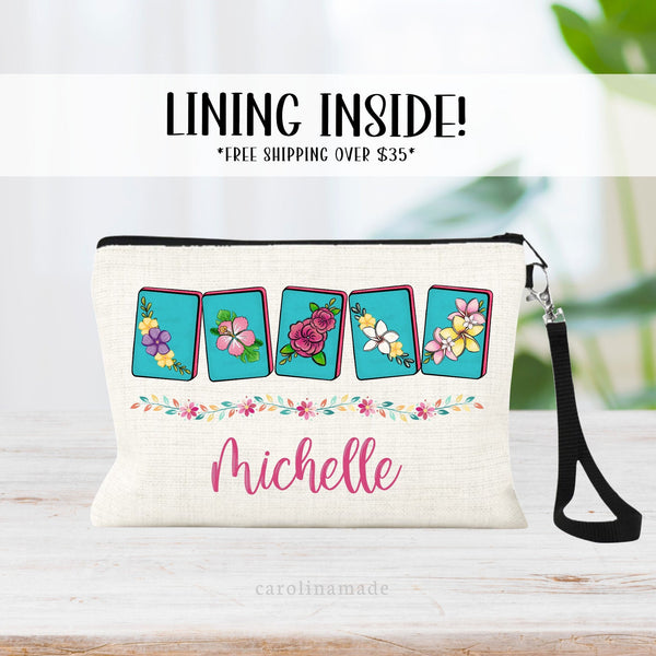 This linen zipper pouch features a colorful floral design with mahjong tiles, a floral border and is personalized with your name.