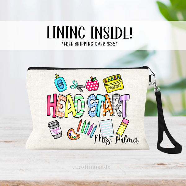 This linen zipper pouch features the text Head Start with clipart for glue, scissors, crayons, coffee, paint, crayons, paper, pencil. It is personalized in the bottom corner with your name.