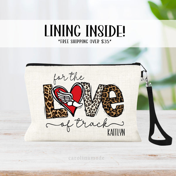 This linen zipper pouch features text that says For the Love of Track with a heart and track shoe symbol in the center where the O would go. It is personalized in the corner with your name.