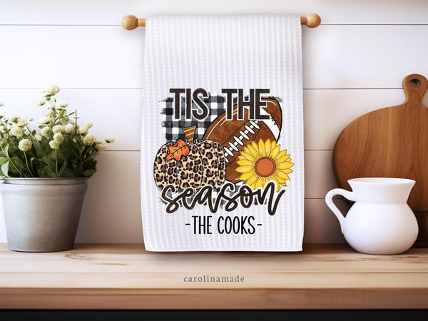 This white waffle towel shows a leopard print pumpkin, a football and a sunflower. Perfect Fall decor for kitchen & bathroom. It says Tis the season and is personalized with your family name at the bottom.