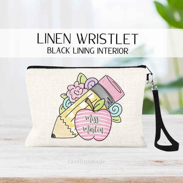 This linen wristlet zipper pouch shows a flower, pencil & apple design perfect for teachers or students alike! Personalize with their name in the center of the apple.