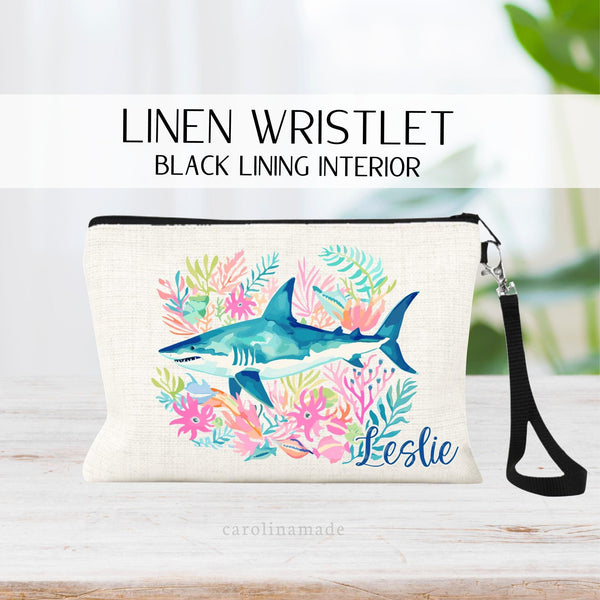 This linen zipper pouch features a pretty tropical sea coral design with large shark in the center. It is personalized in the corner with your name.