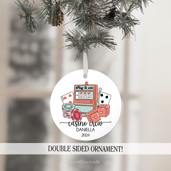 This ornament features a casino theme background with different casino elements - poker chips, dice, playing cards and slot machine. It says Casino Crew at the bottom. Then it is personalized with your name and the year.