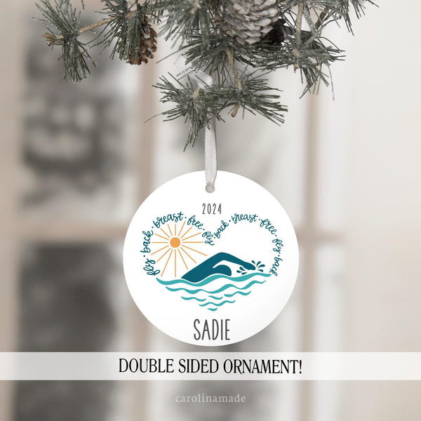 This fun swimmer ornament features the text: fly back breast free fly in the shape of a heart with a simmer & the sun in the center. The top is personalized with the year and the bottom has a name.