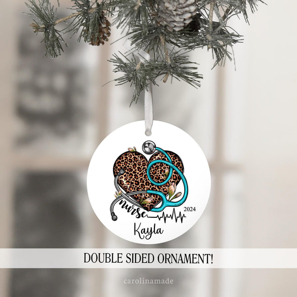 This ornament features a leopard print heart with a blue stethoscope over it with flowers. Personalized at the bottom with a name.