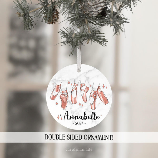 This personalized ornaments shows ballerina slippers in different designs in a rose gold color with matching stars around it. The bottom is personalized with you dancers name and year.