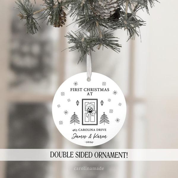 First Christmas at our new home. Personalized with address, couples names and the year. Features a black & white minimalist design with wreath, front door, trees & snow flakes.
