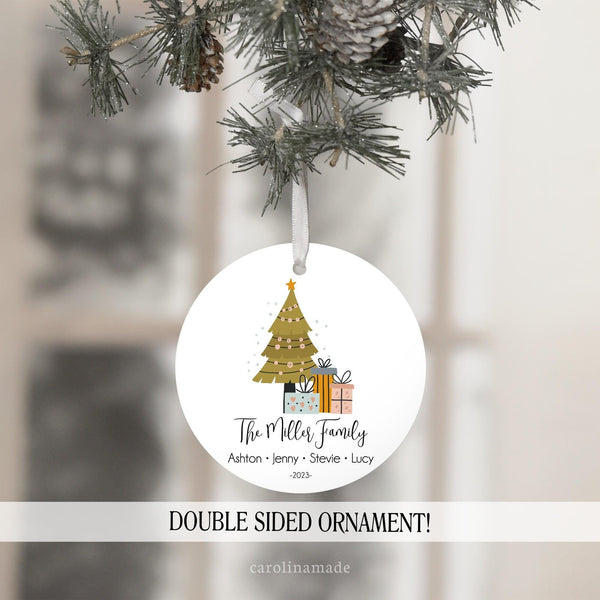 This Christmas Ornament has a tree and presents. The bottom is personalized with Family name and then has individual names at the bottom and year.