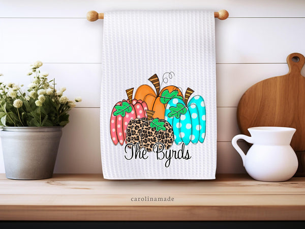 fun colorful pumpkins are featured on this white waffle weave towel. and it is personalized at the bottom with your name