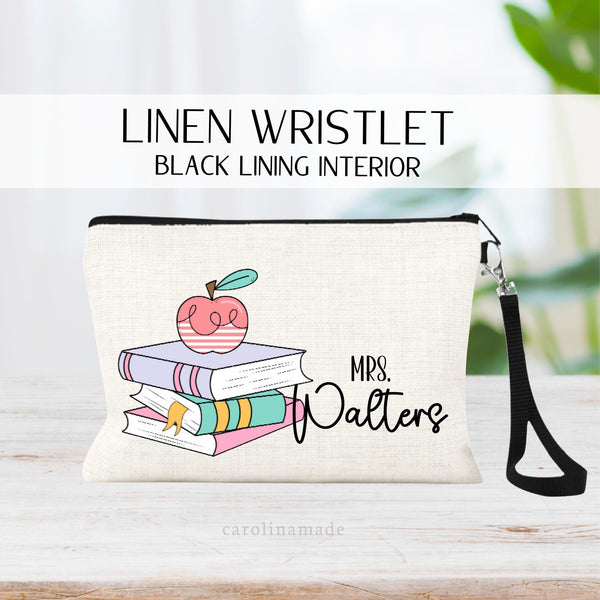 This linen zipper pouch is perfect for teachers! It has a colorful girly book stack and an apple on top. Next to the books it is personalized with your teachers name.