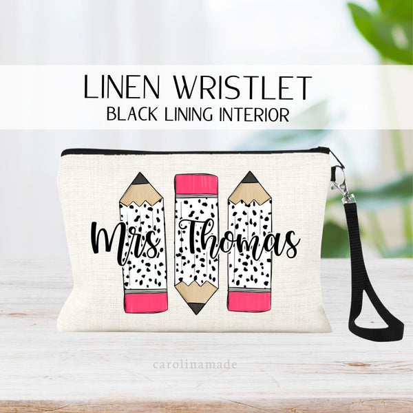 This fun zipper pouch features three large pencils in the center. Pink eraser then dalmatian print on the pencils. The center is personalized with a teachers name.