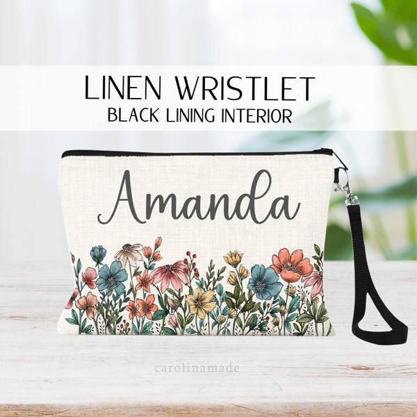 Beautiful floral zipper pouch that comes with black wristlet and can be used for makeup, travel, pens & more! Flowers of blue, pinks, yellows and greenery. Personalized with your name at the top.