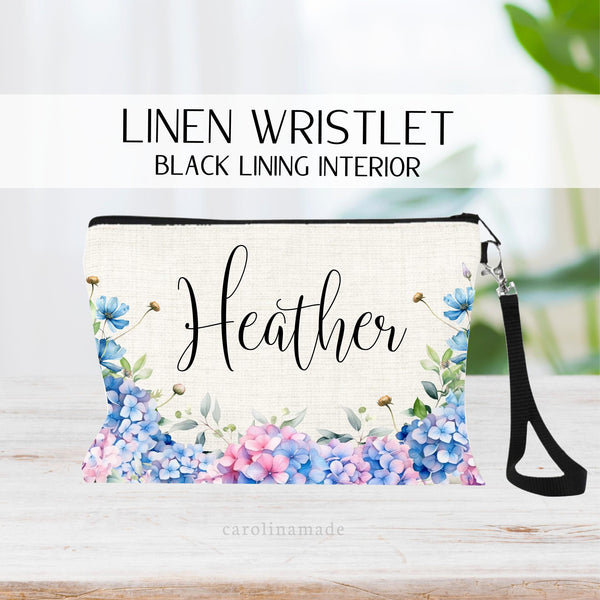 This zipper pouch features blue hydrangea flowers along the bottom border and is personalized at the top with your name.