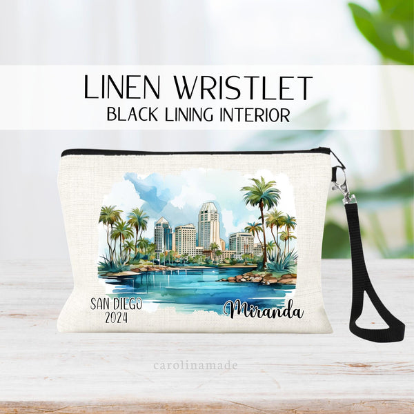 Watercolor San Diego Downtown Beach Scene with palm trees in the center of the wristlet. The bottom says San Diego and the current year on the left. The right is personalized with your name.