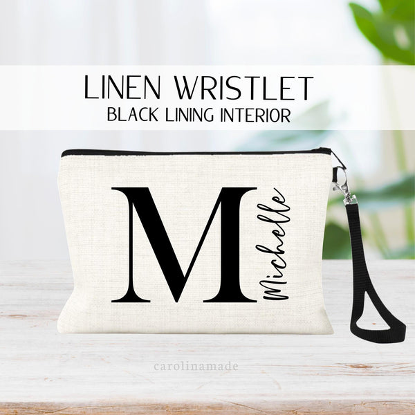 this linen zipper pouch shows a large initial in the center and is personalized with your name next to it.