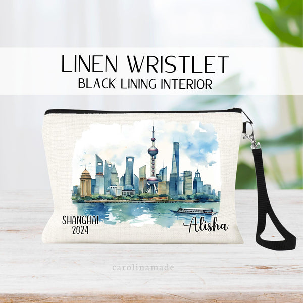 Beautiful watercolor design of downtown Shanghai China in the middle of this linen wristlet bag. It is personalized with your name on bottom right, with Shanghai  and the year on the bottom left.