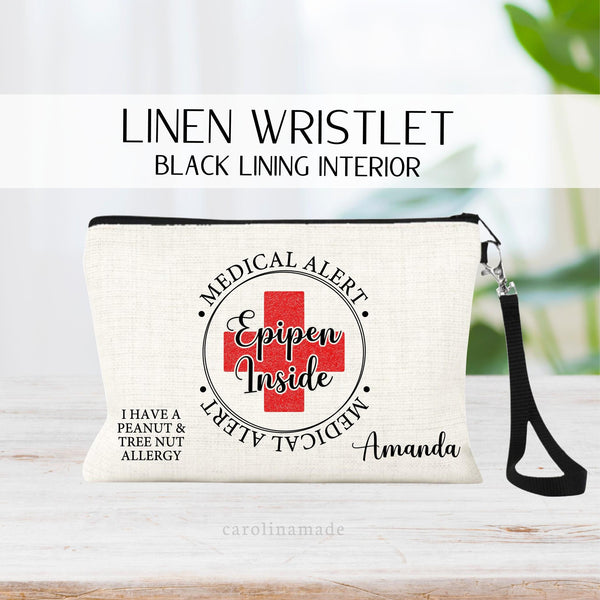This linen wristlet features a circle with a red printed glitter cross in the center. It says Medical Alert around the circle and in the center over the cross it says Epipen inside. Personalize the corners with your allergies and name.