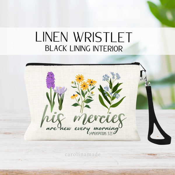 This linen wristlet features a watercolor floral design with three flowers are the top with greenery. The bible verse Lamentations 3:22-23 is under it. His mercies are new every morning. Beautiful Christian bible scripture verse makeup bag!