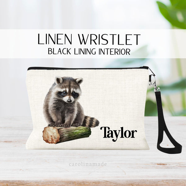 This linen zipper pouch features a watercolor racoon with greenery and is personalized with your name next to it. Perfect for travel, makeup, pens and more!