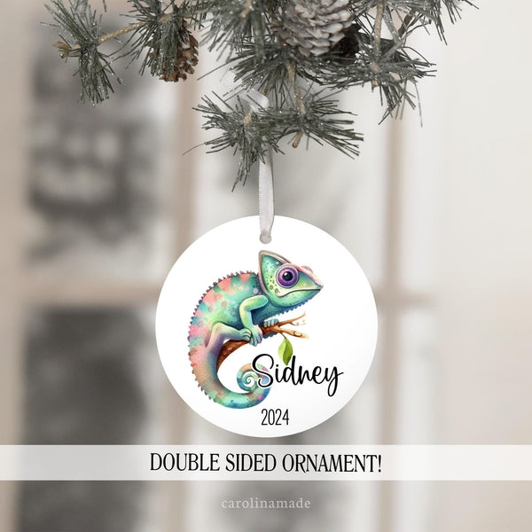 This beautiful ornament shows a watercolor chameleon in hues of blue green and pinks. Personalize with your name next to it and the current year.
