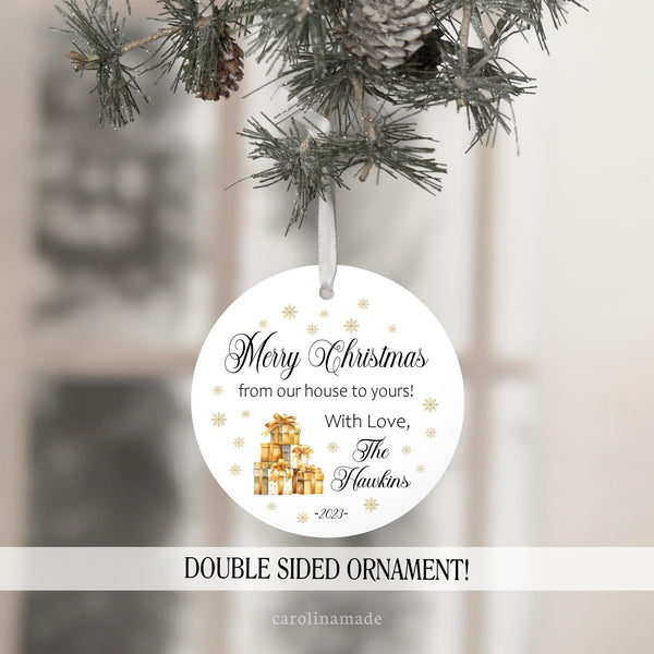 Merry Christmas from our house to yours. Featuring gold presents stacked & gold snow flakes. Personalized with Family name and year.