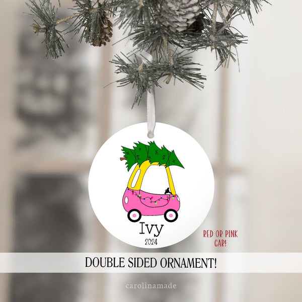 Toddler Christmas Ornament with red or pink car, christmas tree, and string lights. Personalized at the bottom with name and year.