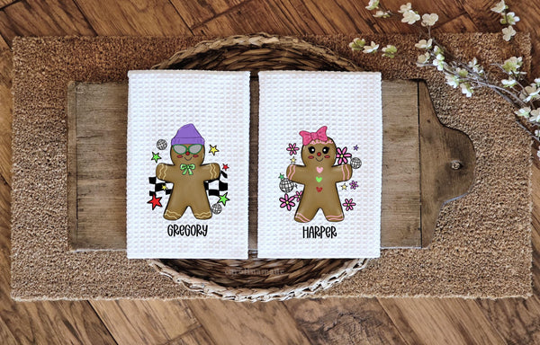 this listing features matching boy and girl gingerbread people and is personalized with a name under it.