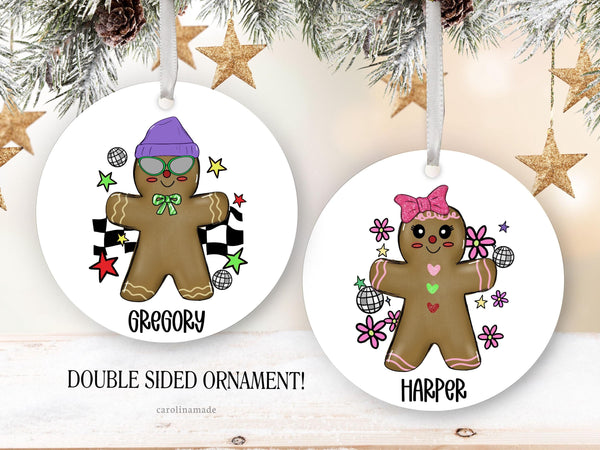 This kids Christmas ornament shows boy and girl gingerbread people. Personalize with childs name at the bottom
