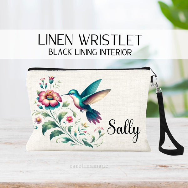 Beautiful hummingbird zipper pouch with pink flowers and greenery. Vibrant color. Personalized with your name