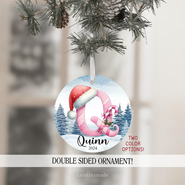 This Christmas ornament features a snowy background with a custom colorful initial on the front in your choice of blue or pink. Personalize with their name and the year.