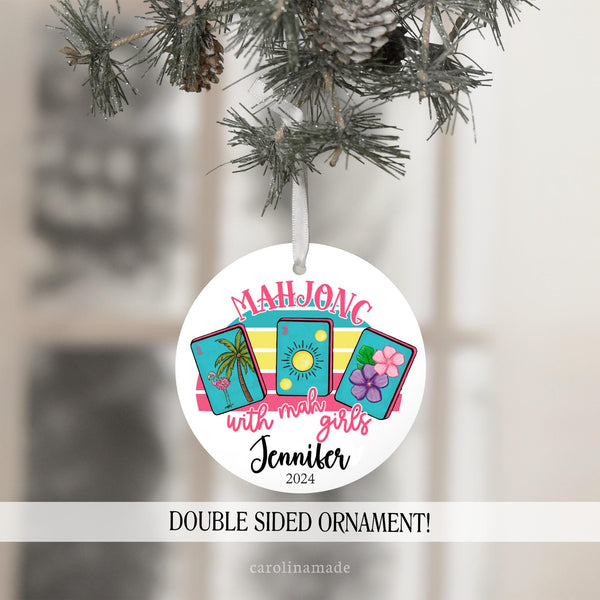 This christmas ornament features three mahjong cards and text that says: Mahjong with mah girls. It is personalized with name and year at the bottom.