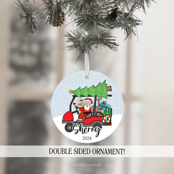This ornament features a snowy background with a red golf cart and christmas tree on top. It has Santa and Mrs Clause on it with presents.